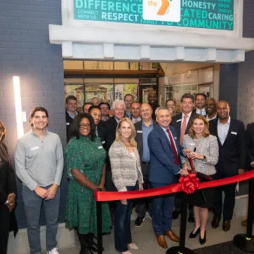 board members and senior leadership cutting ribbon at YMCA Junior Achievement at Storefront 