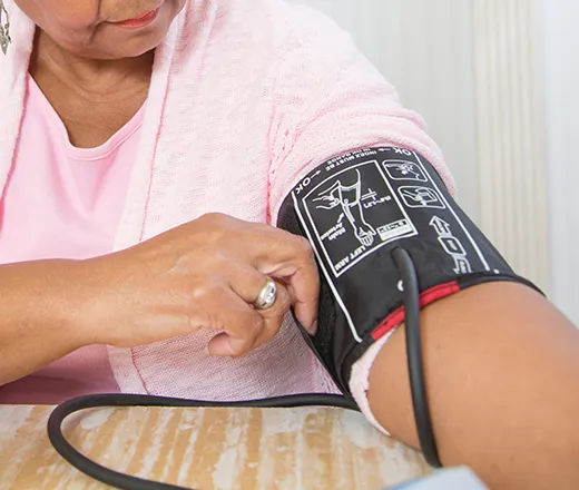 Woman monitoring her blood pressure