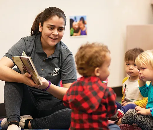 Early learning teacher reading to toddlers