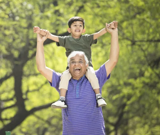 Granddad holding up his grandchild on his shoulders